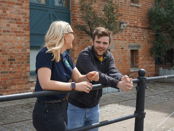 young person and adult talking andsmiling