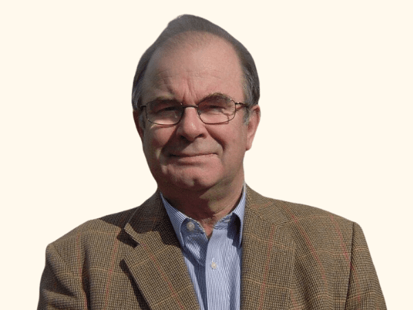 headshot of an older gentleman in glasses and a smart jacket and shirt