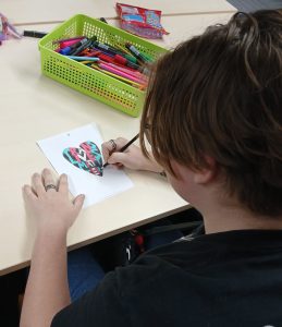 A Young Person Drawing in an Arcus Session